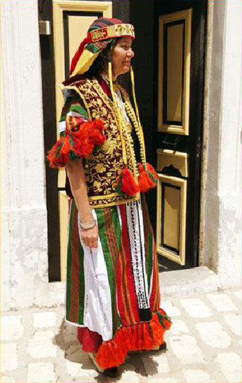 Tunisian woman in traditional woven and embroidered costume