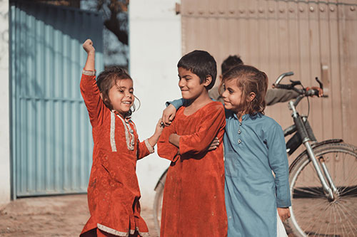 children in Pakistan dress in traditional long upper garments