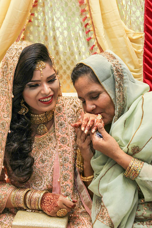 Pakistani bride and her mother in traditional wedding clothes